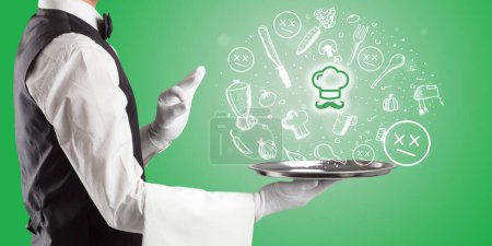 Photo for Waiter holding silver tray with master chef icons coming out of it, health food concept - Royalty Free Image
