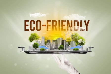 Foto de Camarero sirviendo eco ciudad con inscripción ECO-FRIENDLY, concepto de energía renovable - Imagen libre de derechos