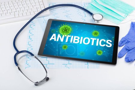 Photo for Close-up view of a tablet pc with ANTIBIOTICS inscription, microbiology concept - Royalty Free Image