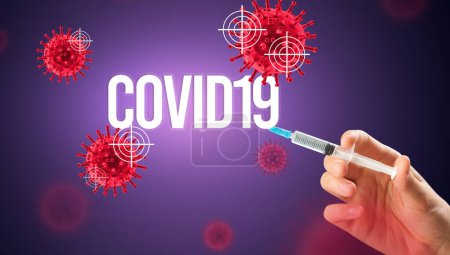 Photo for Close-up view of doctors hand in a white glove holding syringe with COVID19 inscription, coronavirus antidote concept - Royalty Free Image