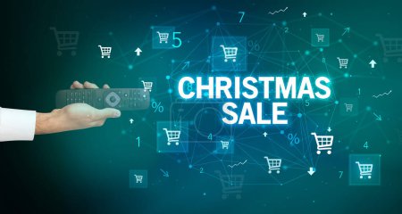 Photo for Hand holding wireless peripheral with CHRISTMAS SALE inscription, online shopping concept - Royalty Free Image