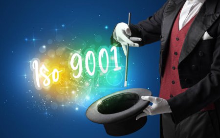 Téléchargez les photos : Main de magicien évoquer avec baguette et inscription Iso 9001, concept shopping - en image libre de droit