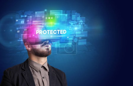 Téléchargez les photos : Homme d'affaires regardant à travers des lunettes de réalité virtuelle avec inscription PROTÉGÉE, concept de sécurité innovant - en image libre de droit
