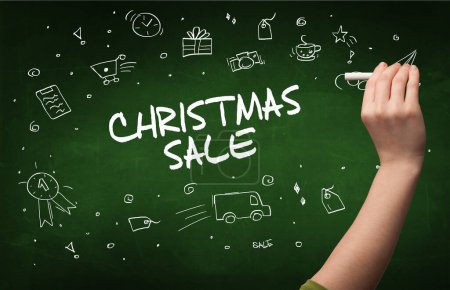 Photo for Hand drawing CHRISTMAS SALE inscription with white chalk on blackboard, online shopping concept - Royalty Free Image