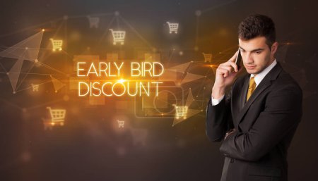 Photo for Businessman with shopping cart icons and EARLY BIRD DISCOUNT inscription, online shopping concept - Royalty Free Image