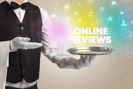 Photo for Waiter serving social networking with ONLINE REVIEWS inscription, new media concept - Royalty Free Image