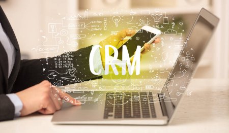 Photo for Hand working on new modern computer with CRM abbreviation, modern technology concept - Royalty Free Image