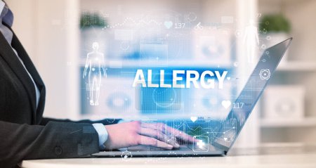 Photo for Doctor working a health check with ALLERGY inscription, recording medical test results - Royalty Free Image