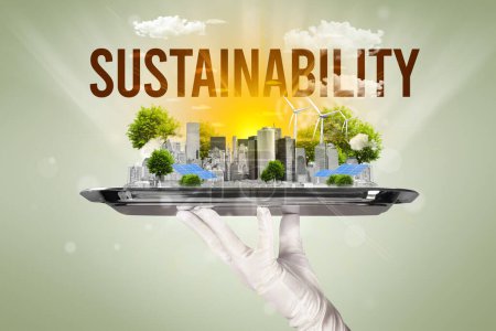 Foto de Camarero sirviendo eco ciudad con inscripción SOSTENIBILIDAD, concepto de energía renovable - Imagen libre de derechos