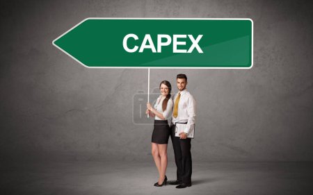 Photo for Young business person in casual holding road sign with CAPEX inscription, new business direction concept - Royalty Free Image