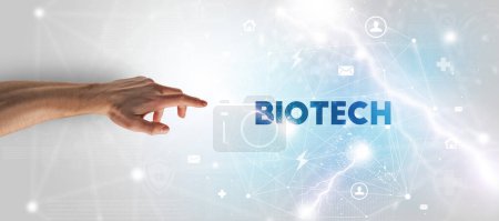 Photo for Hand pointing at BIOTECH inscription, modern technology concept - Royalty Free Image