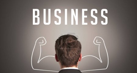 Téléchargez les photos : Vue arrière d'un homme d'affaires avec inscription BUSINESS, concept d'entreprise puissant - en image libre de droit
