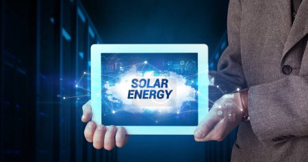 Photo for Young business person working on tablet and shows the inscription: SOLAR ENERGY - Royalty Free Image