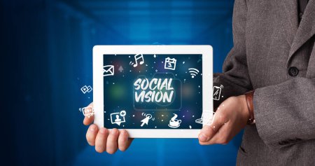 Photo for Young business person working on tablet and shows the inscription: SOCIAL VISION - Royalty Free Image