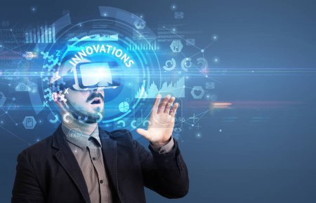 Photo for Businessman looking through Virtual Reality glasses with INNOVATIONS inscription, innovative technology concept - Royalty Free Image