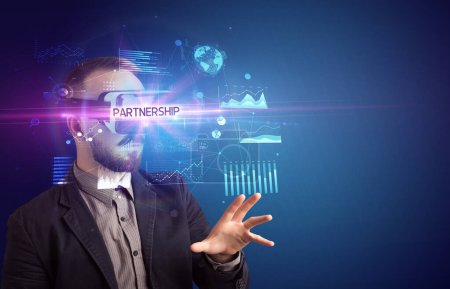 Photo for Businessman looking through Virtual Reality glasses with PARTNERSHIP inscription, new business concept - Royalty Free Image