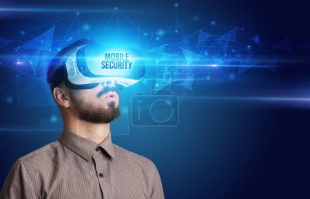 Photo for Businessman looking through Virtual Reality glasses with MOBILE SECURITY inscription, cyber security concept - Royalty Free Image