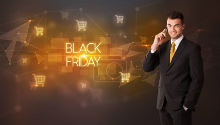 Photo for Businessman with shopping cart icons and BLACK FRIDAY inscription, online shopping concept - Royalty Free Image