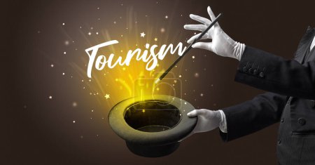 Photo for Magician is showing magic trick with Tourism inscription, traveling concept - Royalty Free Image
