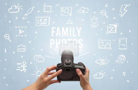 Photo for Hand taking picture with digital camera and FAMILY PHOTOS inscription, camera settings concept - Royalty Free Image