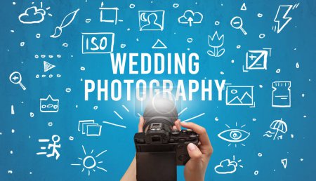 Photo for Hand taking picture with digital camera and WEDDING PHOTOGRAPHY inscription, camera settings concept - Royalty Free Image