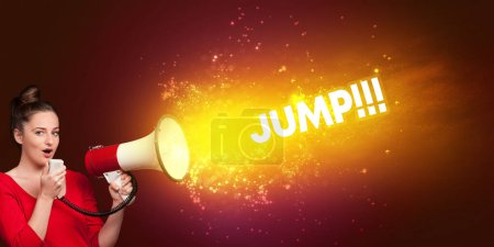 Photo for Young woman yelling to loudspeaker with JUMP inscription, modern media concept - Royalty Free Image