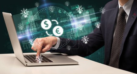 Photo for Business hand working in stock market with dollar - euro exchange icons coming out from laptop screen - Royalty Free Image