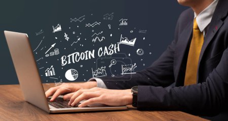 Photo for Businessman working on laptop with BITCOIN CASH inscription, modern business concept - Royalty Free Image
