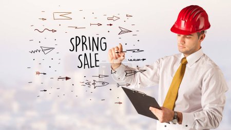 Photo for Handsome businessman with helmet drawing SPRING SALE inscription, contruction sale concept - Royalty Free Image