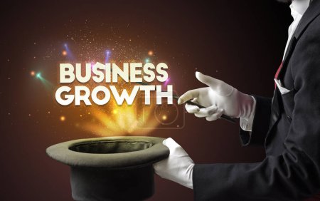 Photo for Illusionist is showing magic trick with BUSINESS GROWTH inscription, new business model concept - Royalty Free Image