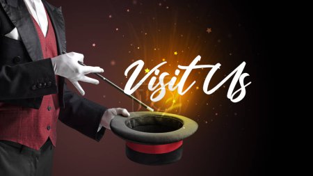 Photo for Magician is showing magic trick with Visit Us inscription, traveling concept - Royalty Free Image