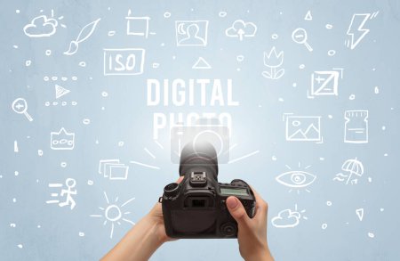 Photo for Hand taking picture with digital camera and DIGITAL PHOTO inscription, camera settings concept - Royalty Free Image