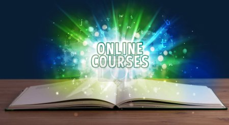 Photo for ONLINE COURSES inscription coming out from an open book, educational concept - Royalty Free Image