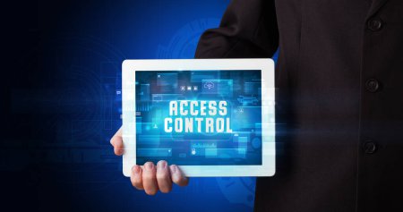 Photo for Young business person working on tablet and shows the digital sign: ACCESS CONTROL - Royalty Free Image