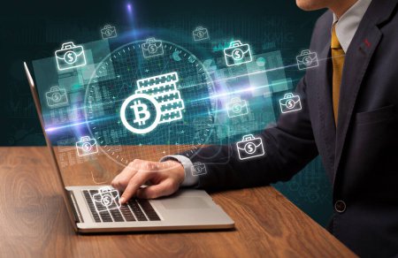 Photo for Business hand working in stock market with bitcoin saving icons coming out from laptop screen - Royalty Free Image