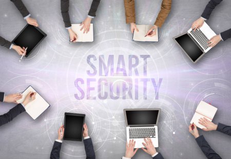 Photo for Group of people in front of a laptop with SMART SECURITY insciption, web security concept - Royalty Free Image
