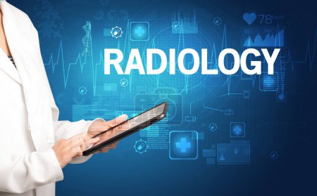 Photo for Young doctor writing down notes with RADIOLOGY inscription, healthcare concept - Royalty Free Image