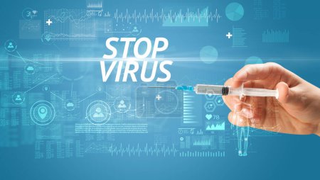 Téléchargez les photos : Aiguille seringue avec vaccin viral et STOP inscription VIRUS, concept antidote - en image libre de droit