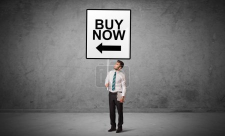 Photo for Business person holding a traffic sign with BUY NOW inscription, new idea concept - Royalty Free Image