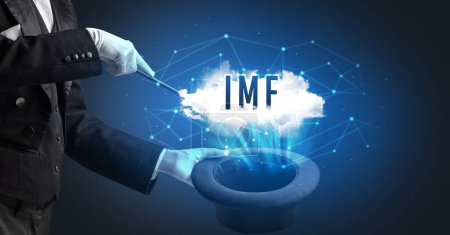 Foto de Mago está mostrando truco de magia con la abreviatura del FMI, concepto de tecnología moderna - Imagen libre de derechos