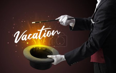 Photo for Magician is showing magic trick with Vacation inscription, traveling concept - Royalty Free Image