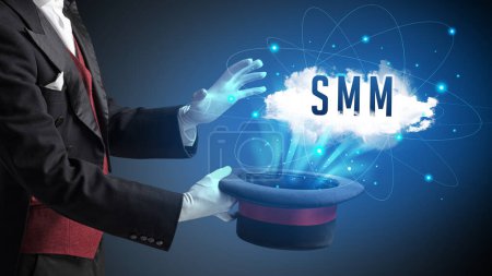 Foto de Mago está mostrando truco de magia con abreviatura SMM, concepto de tecnología moderna - Imagen libre de derechos