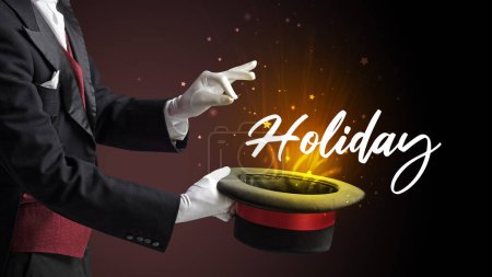 Photo for Magician is showing magic trick with Holiday inscription, traveling concept - Royalty Free Image