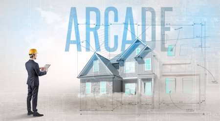 Foto de Joven ingeniero sosteniendo plano con inscripción ARCADE, concepto de planificación de la casa - Imagen libre de derechos