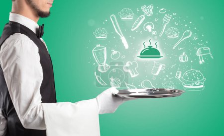 Photo for Waiter holding silver tray with hot food icons coming out of it, health food concept - Royalty Free Image