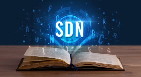 Photo for SDN inscription coming out from an open book, digital technology concept - Royalty Free Image