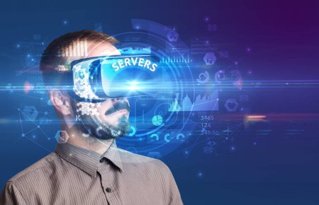 Téléchargez les photos : Homme d'affaires regardant à travers des lunettes de réalité virtuelle avec inscription SERVERS, concept technologique innovant - en image libre de droit