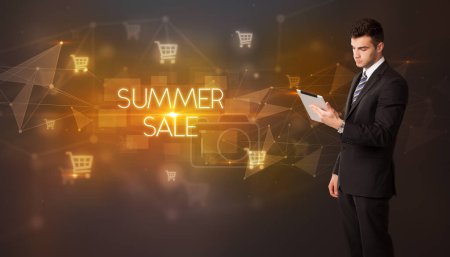 Photo for Businessman with shopping cart icons and SUMMER SALE inscription, online shopping concept - Royalty Free Image
