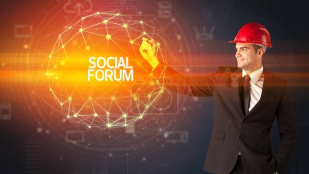 Foto de Hombre de negocios guapo con dibujo casco SOCIAL FORUM inscripción, concepto de construcción social - Imagen libre de derechos