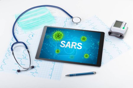 Photo for Close-up view of a tablet pc with SARS inscription, microbiology concept - Royalty Free Image